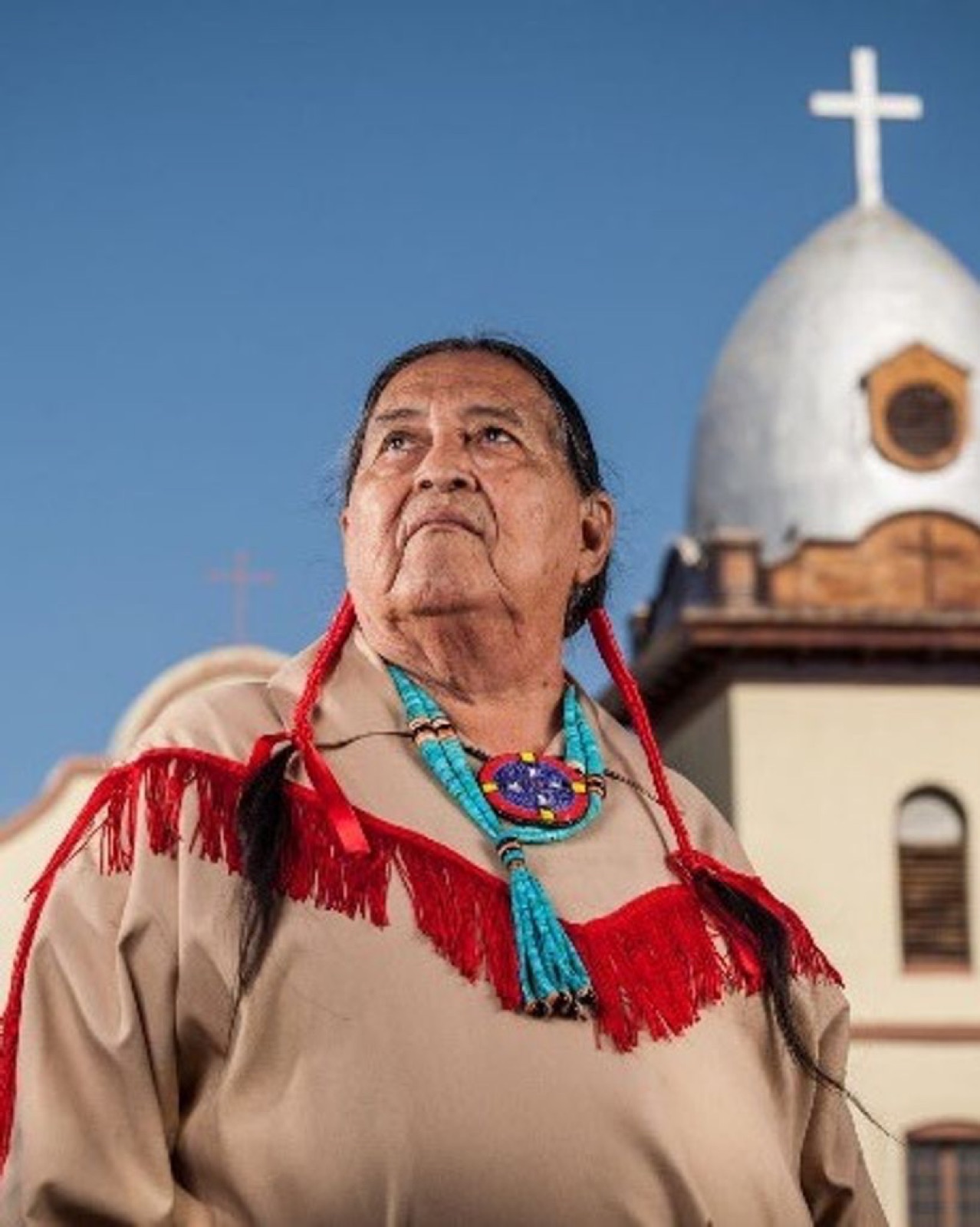 Cacique Sierra in traditional dress before the Ysleta Mission