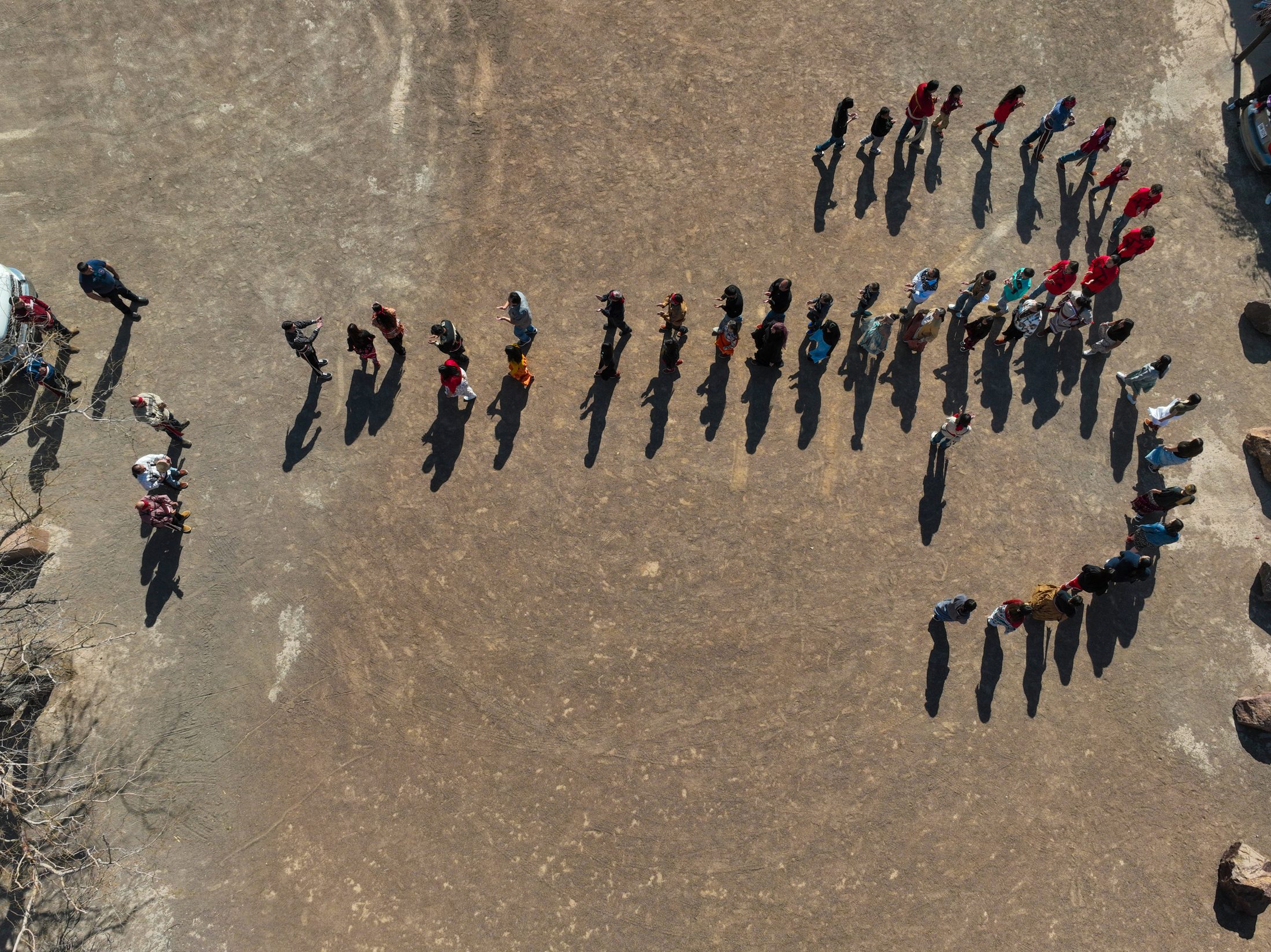 Aerial view of Tigua community members gathered in a circle